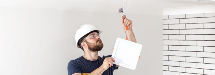 Electrician Installing Downlight 